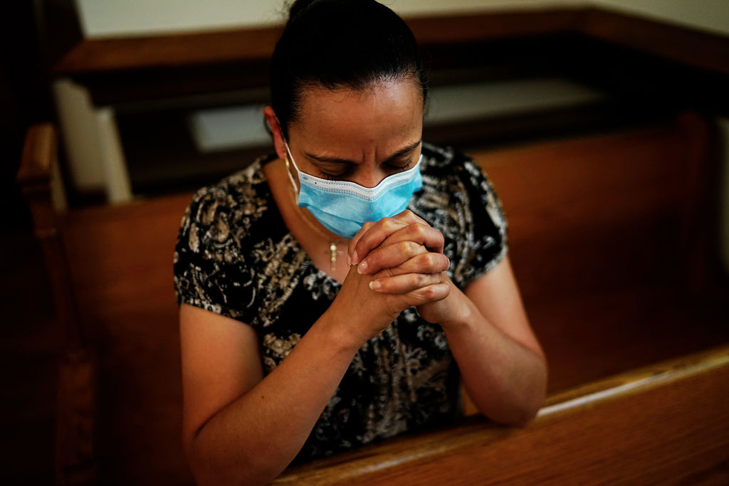 Maribel Arzate prays during mass